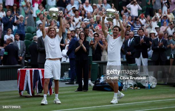 Matthew Ebden of Australia and partner Max Purcell of Australia celebrate with the trophy after winning match point against Nikola Mektic of Croatia...
