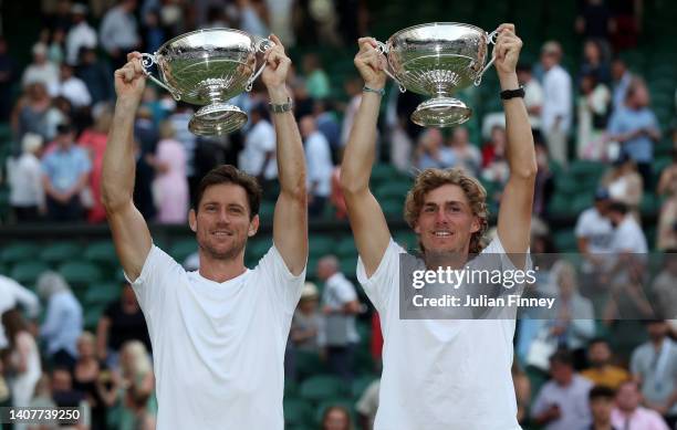 Matthew Ebden of Australia and partner Max Purcell of Australia celebrate with the trophy after winning match point against Nikola Mektic of Croatia...