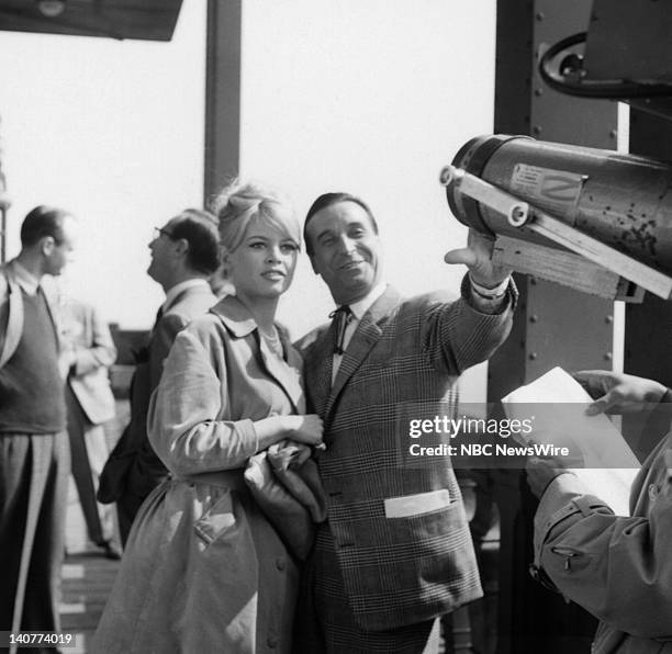 In Paris 1959" -- Pictured: French actress Brigitte Bardot, director Christian-Jaque at the Eiffel Tower in Paris, France from April 27 - May 1, 1959...