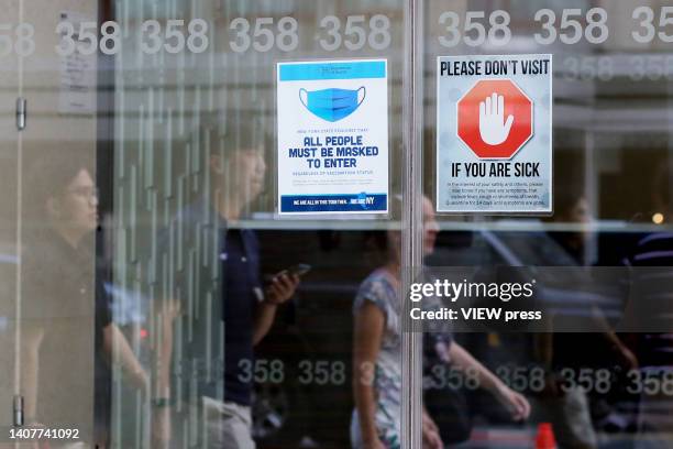 Masks required sign is displayed, on July 09, 2022 in New York. New York City public health officials urged people to return to mask-wearing to help...