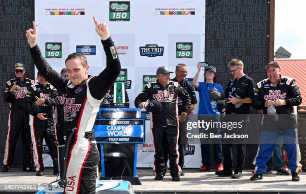 Parker Kligerman, driver of the Food Country USA/Tide Chevrolet, celebrates in victory lane after winning the NASCAR Camping World Truck Series...