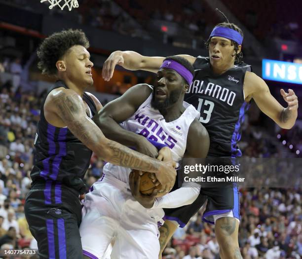 Neemias Queta of the Sacramento Kings vies for a rebound against Paolo Banchero and R.J. Hampton of the Orlando Magic during the 2022 NBA Summer...