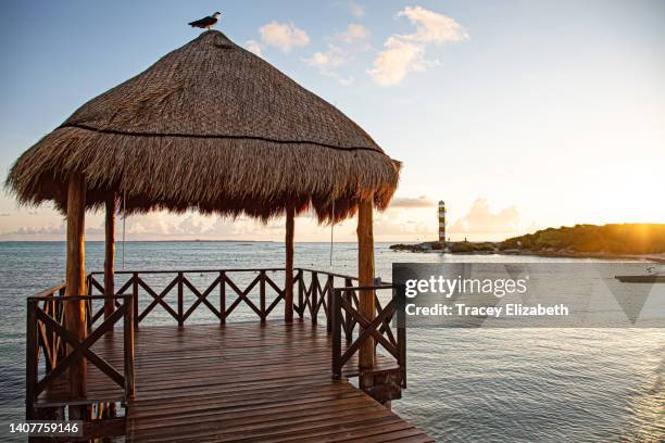 tiki hut and cancun lighthouse - thatched roof huts stock pictures, royalty-free photos & images