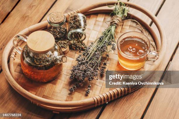 green tea with herbals. tea with oregano on the wooden background. - origano foto e immagini stock