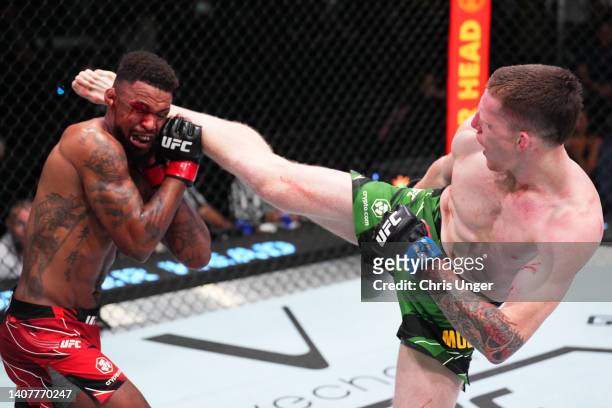 Jamie Mullarkey of Australia kicks Michael Johnson in their lightweight fight during the UFC Fight Night event at UFC APEX on July 09, 2022 in Las...
