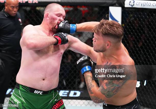 Chase Sherman punches Jared Vanderaa in their heavyweight fight during the UFC Fight Night event at UFC APEX on July 09, 2022 in Las Vegas, Nevada.