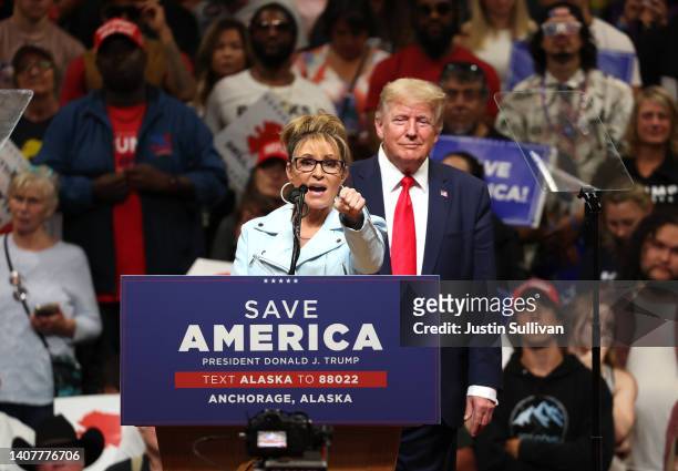 Republican U.S. House candidate former Alaska Gov. Sarah Palin speaks as former U.S. President Donald Trump looks on during a "Save America" rally at...