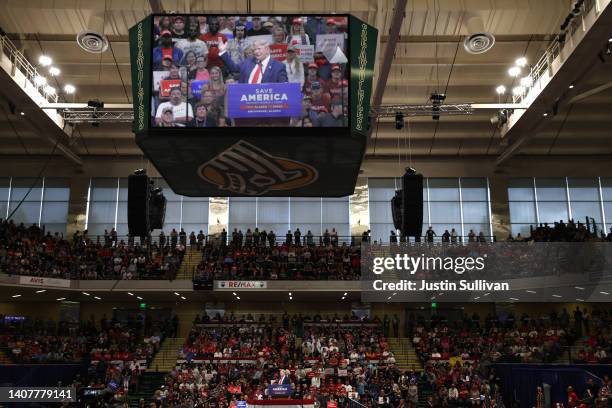 Former U.S. President Donald Trump is seen on a video screen as he speaks during a "Save America" rally at Alaska Airlines Center on July 09, 2022 in...