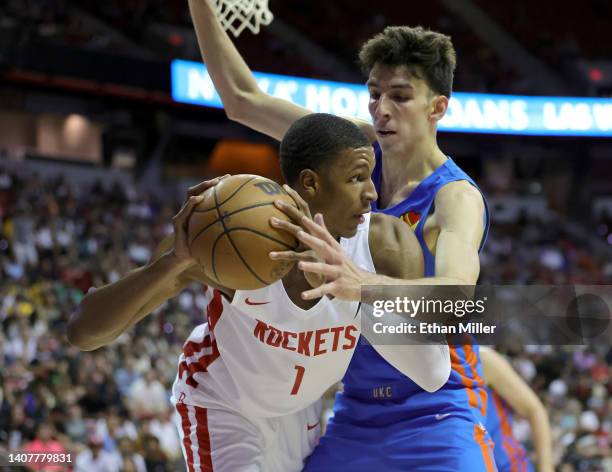 Jabari Smith Jr. #1 of the Houston Rockets secures a loose ball against Chet Holmgren of the Oklahoma City Thunder during the 2022 NBA Summer League...