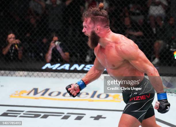 Rafael Fiziev of Kazakstan celebrates after his knockout victory over Rafael Dos Anjos of Brazil in their lightweight fight during the UFC Fight...