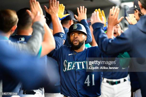 Carlos Santana of the Seattle Mariners celebrates with teammates after hitting a two run home run during the seventh inning against the Toronto Blue...