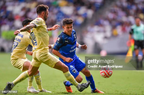 Arturo González of Monterrey fights for the ball with Miguel Layún and Alejandro Zendejas of América during the 2nd round match between Monterrey and...