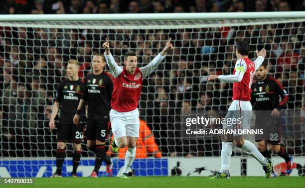 Arsenal's French defender Laurent Koscielny celebrates scoring the opening goal during an UEFA Champions League round of 16 second leg football match...