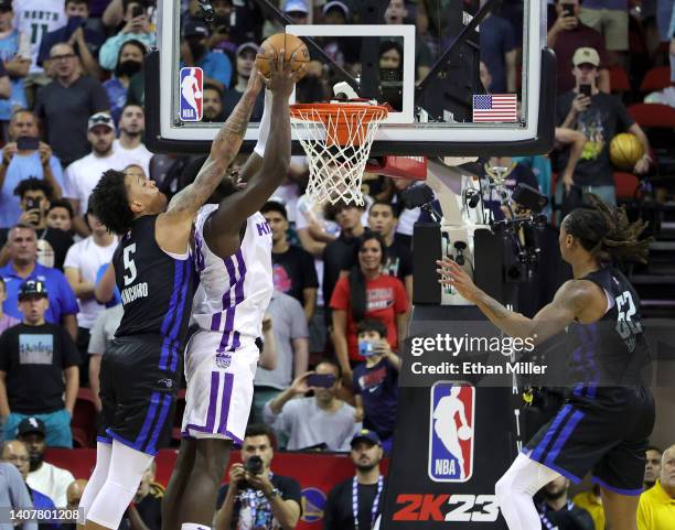 Paolo Banchero of the Orlando Magic blocks an alley-oop dunk attempt by Neemias Queta of the Sacramento Kings that would have won the game in...