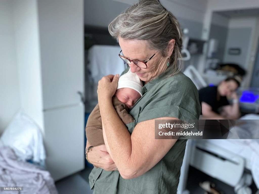 Grandmother holding just born grandchild