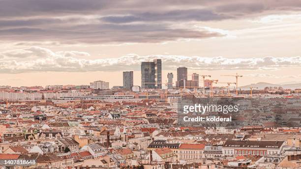 panoramic view of vienna historic residential neighborhoods with distant view of modern office buildings at sunset. - wiener graben stock-fotos und bilder