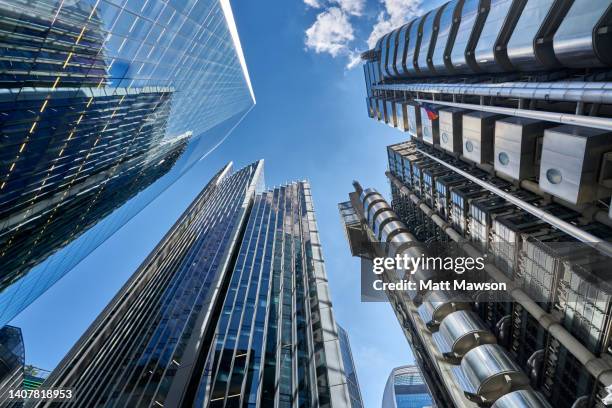 low angle view  looking down lime street to lloyds of london building, the scalpel building, willis building and the leadenhall building in the city of london uk - lloyds of london stock-fotos und bilder