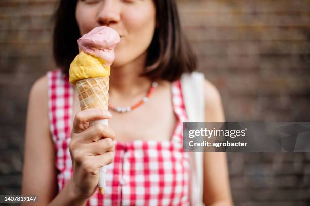 beautiful woman eating ice cream - woman ice cream stock pictures, royalty-free photos & images