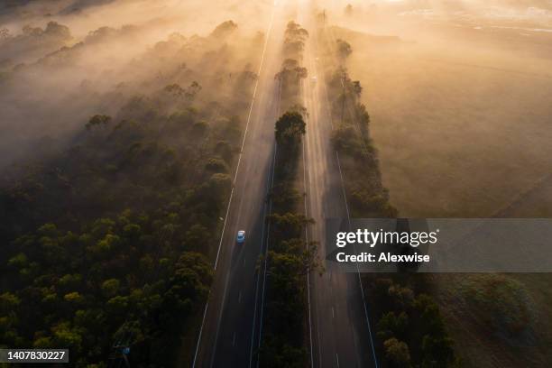 aerial fog highway at sunrise - sunrise dawn stock pictures, royalty-free photos & images