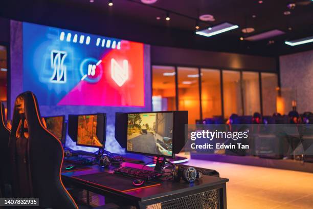 illuminated interior of esports cybercafe with video game competition setup - internet cafe stock pictures, royalty-free photos & images