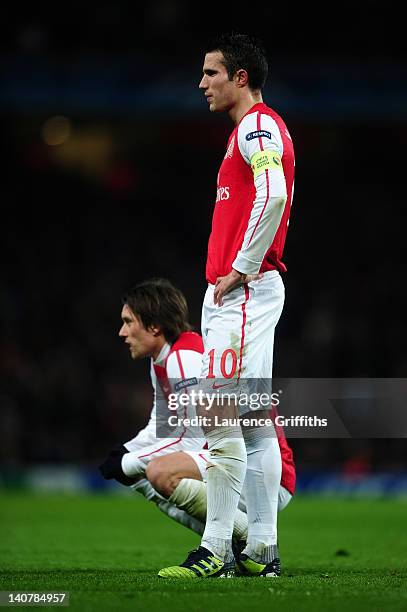 Robin van Persie and Tomas Rosicky of Arsenal look dejected during the UEFA Champions League Round of 16 second leg match between Arsenal and AC...