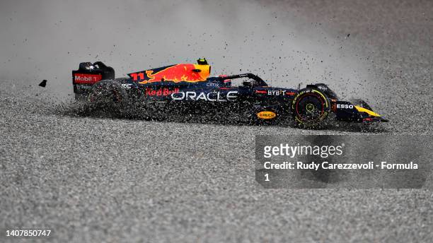 Sergio Perez of Mexico driving the Oracle Red Bull Racing RB18 runs through the gravel after a collision with George Russell of Great Britain and...