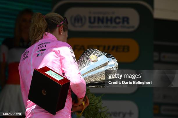 Annemiek Van Vleuten of Netherlands and Movistar Team celebrates winning the pink leader jersey and overall race trophy on the podium ceremony after...