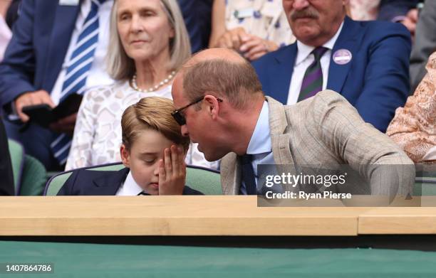 Prince William, Duke of Cambridge and Prince George of Cambridge interact in the Royal Box watching Novak Djokovic of Serbia play Nick Kyrgios of...