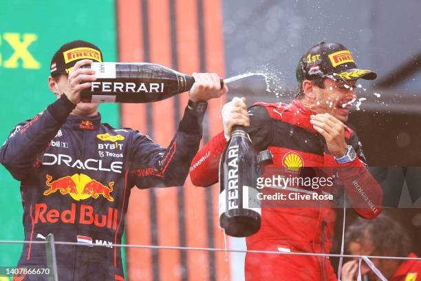 Race winner Charles Leclerc of Monaco and Ferrari and Second placed Max Verstappen of the Netherlands and Oracle Red Bull Racing celebrate on the...