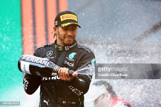 Third placed Lewis Hamilton of Great Britain and Mercedes celebrates on the podium during the F1 Grand Prix of Austria at Red Bull Ring on July 10,...