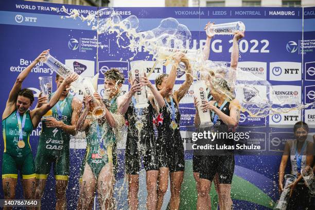 Team's of Australia, Great Britain and Germany celebrate after finishing the ITU World Triathlon Elite Mixed Team Relay with a beer shower during the...