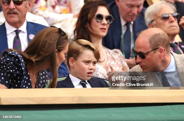 Catherine, Duchess of Cambridge, Prince George of Cambridge and Prince William, Duke of Cambridge interact in the Royal Box watching Novak Djokovic...