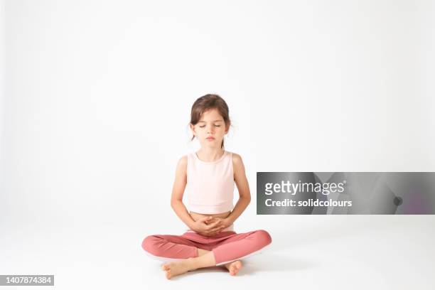 cute girl doing breathing exercise - deep breathing stock pictures, royalty-free photos & images
