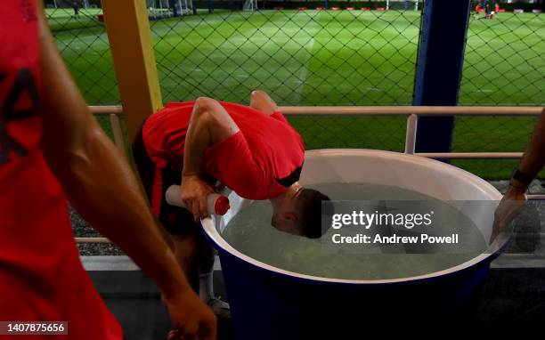 Andy Robertson of Liverpool in an ice bath at the end of a training session at Alpine Football Camp on July 10, 2022 in Bangkok, Thailand.