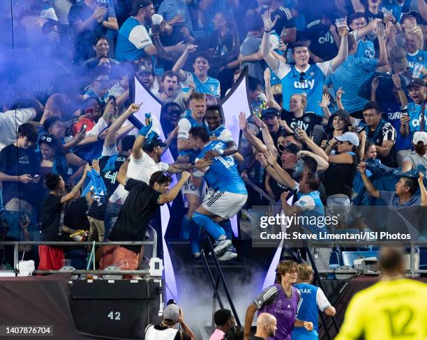 Karol widerski, Harrison Afful and Brandt Bronico of Charlotte FC celebrate with fans after Swiderskis goal during a game between Nashville SC and...