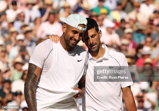 Winner Novak Djokovic of Serbia and runner up Nick Kyrgios of Australia interact by the net following their Men's Singles Final match on day fourteen...