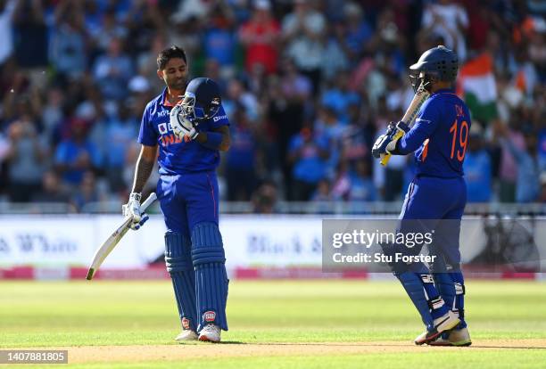 Suryakumar Yadav of India celebrates reaching their century as Dinesh Karthik reacts during the 3rd Vitality IT20 match between England and India at...