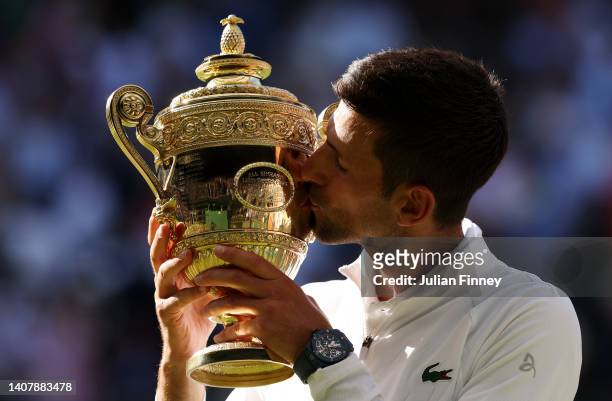 Novak Djokovic of Serbia kisses the trophy following his victory against Nick Kyrgios of Australia during their Men's Singles Final match on day...
