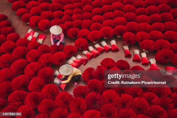 vietnamese woman arranging incense stick on floor at the old traditional house in south of vietnam, traditional art and culture concep - traditional culture stock pictures, royalty-free photos & images