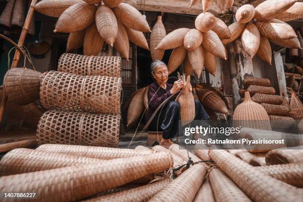 old vietnamese women doing basketry for fishing equipment at morning in thu sy village, vietnam. - basket weaving stock pictures, royalty-free photos & images