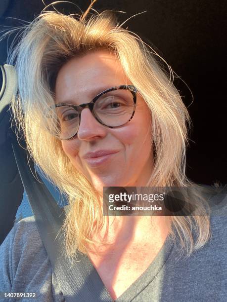 mature woman self-portrait in a car - no make up stockfoto's en -beelden