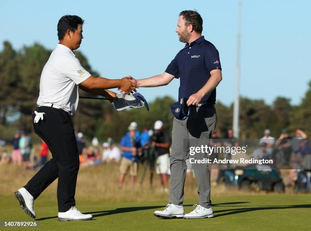 Kim Joo-hyung and Branden Grace of South Africa shake hands on the 18th green during Day Four of the Genesis Scottish Open at The Renaissance Club on...