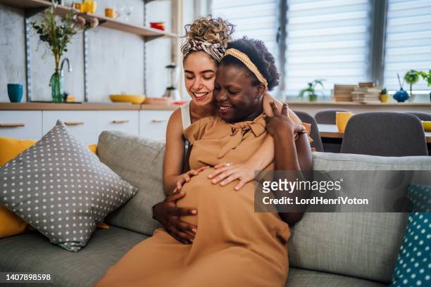 lesbian couple expecting a baby - young family stock pictures, royalty-free photos & images
