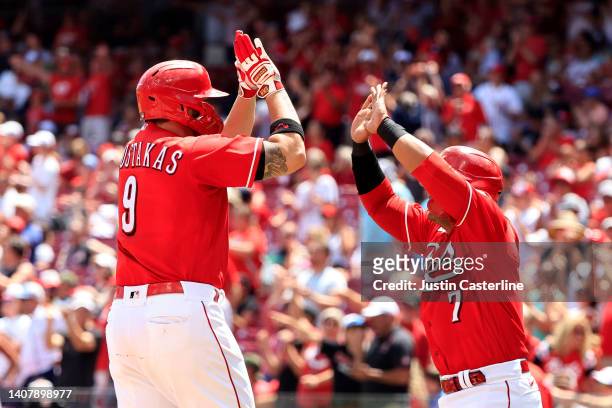 Mike Moustakas of the Cincinnati Reds celebrates with Donovan Solano of the Cincinnati Reds after hitting his 200th home run during the third inning...