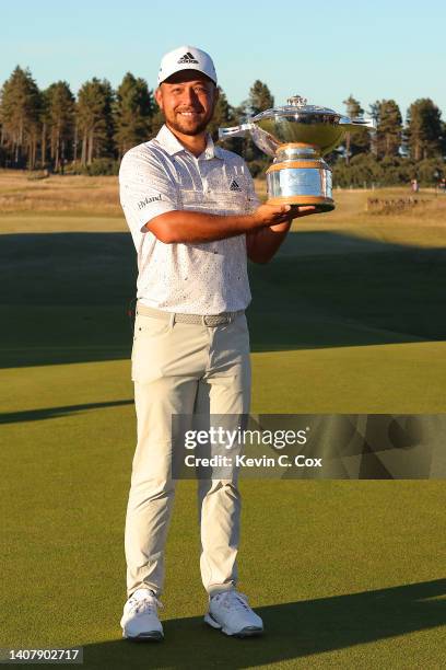 Xander Schauffele of the United States poses with the trophy after winning the Genesis Scottish Open at The Renaissance Club on July 10, 2022 in...