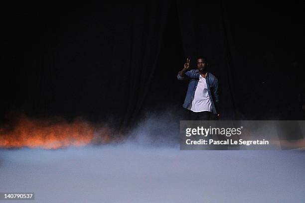 Kanye West acknowledges the applause of the audience after the Kanye West Ready-To-Wear Fall/Winter 2012 show as part of Paris Fashion Week at Halle...