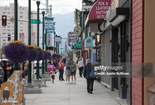 People walk past retail stores in the Mushing district in downtown on July 10, 2022 in Anchorage, Alaska.