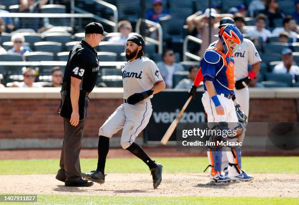 Pinch runner Billy Hamilton of the Miami Marlins scores from third base in the tenth inning after a throwing error by catcher Tomas Nido of the New...