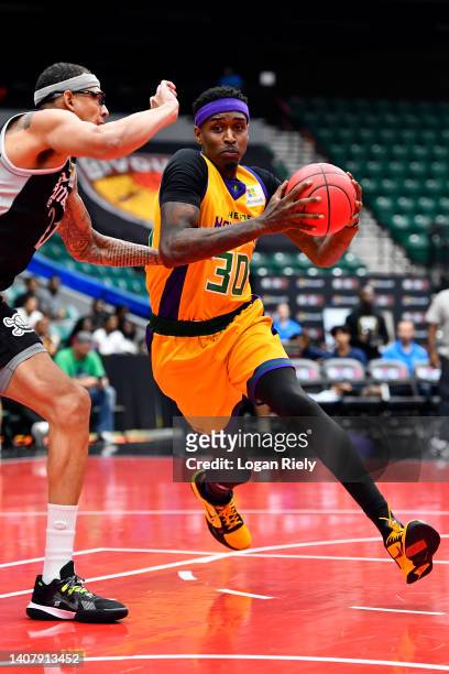 Quincy Miller of the 3 Headed Monsters drives to the basket against Isaiah Austin of the Enemies during the game in BIG3 Week Four at Comerica Center...