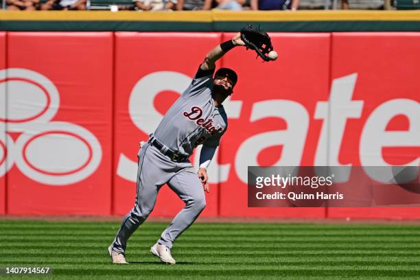 Robbie Grossman of the Detroit Tigers commits a fielding error trying to attempting to catch a fly ball hit by Luis Robert of the Chicago White Sox...